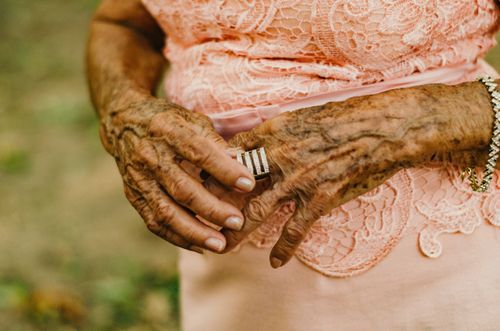 Free Detailed close-up of an elderly woman's hands adorned with rings and bracelets, showcasing aging beauty. Stock Photo
