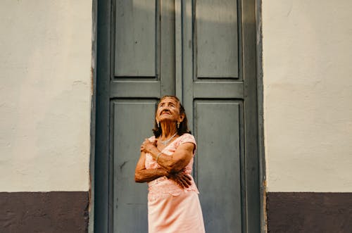 Free Woman Standing in Front Close Door Stock Photo