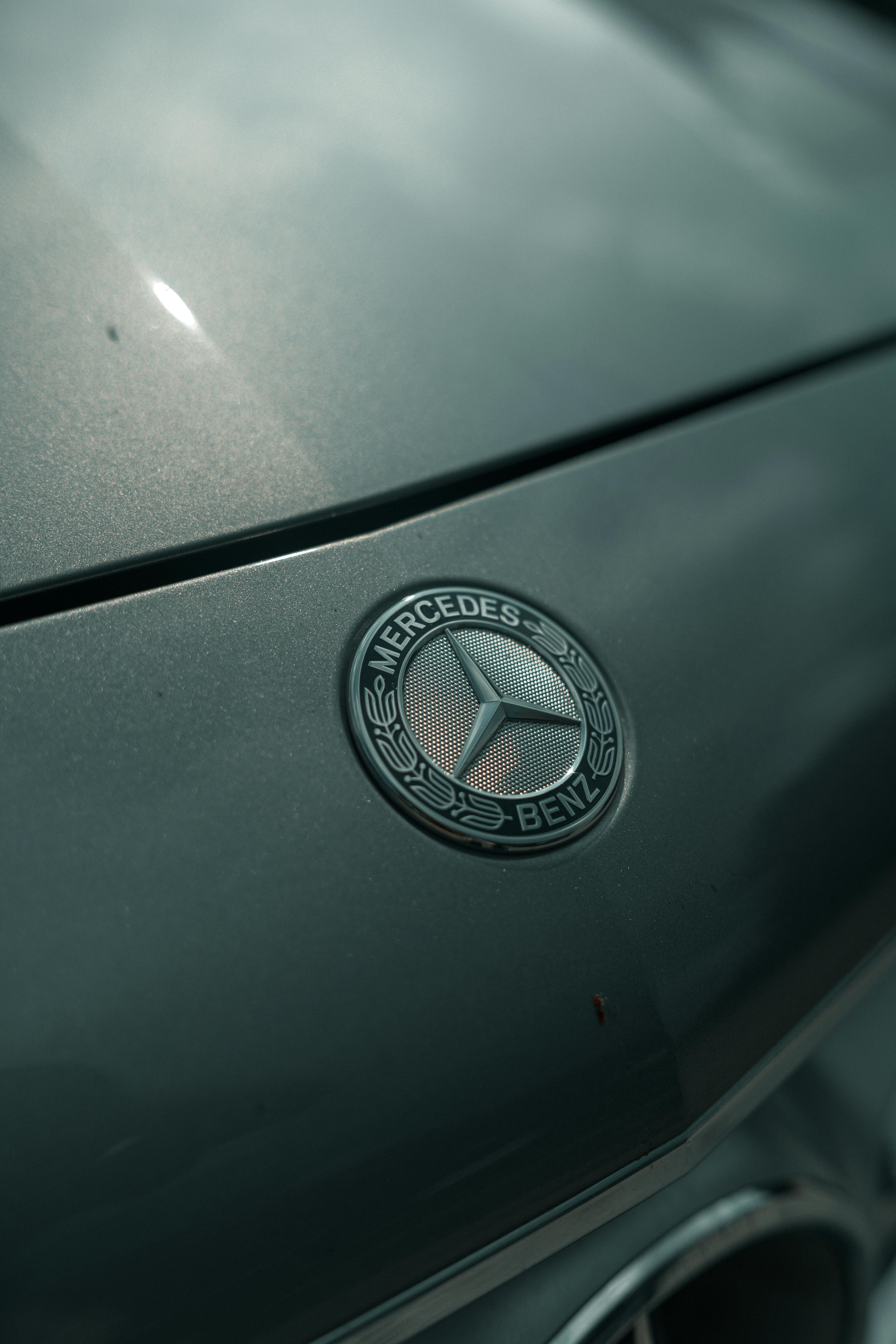 free photo of a close up of the mercedes logo on the hood of a car