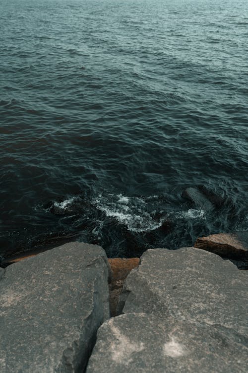 A photo of the ocean with rocks and water