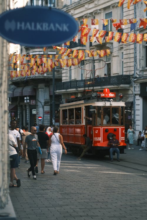 Red Old Tram Running on Street