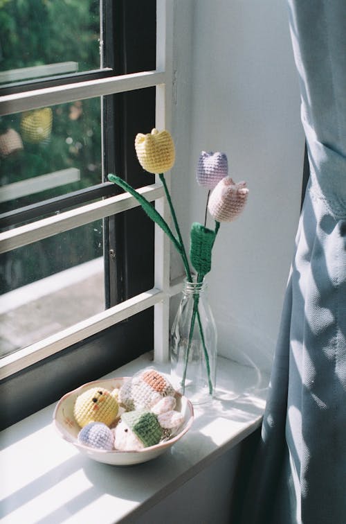 Artificial Flowers and Toys in Bowl on Windowsill