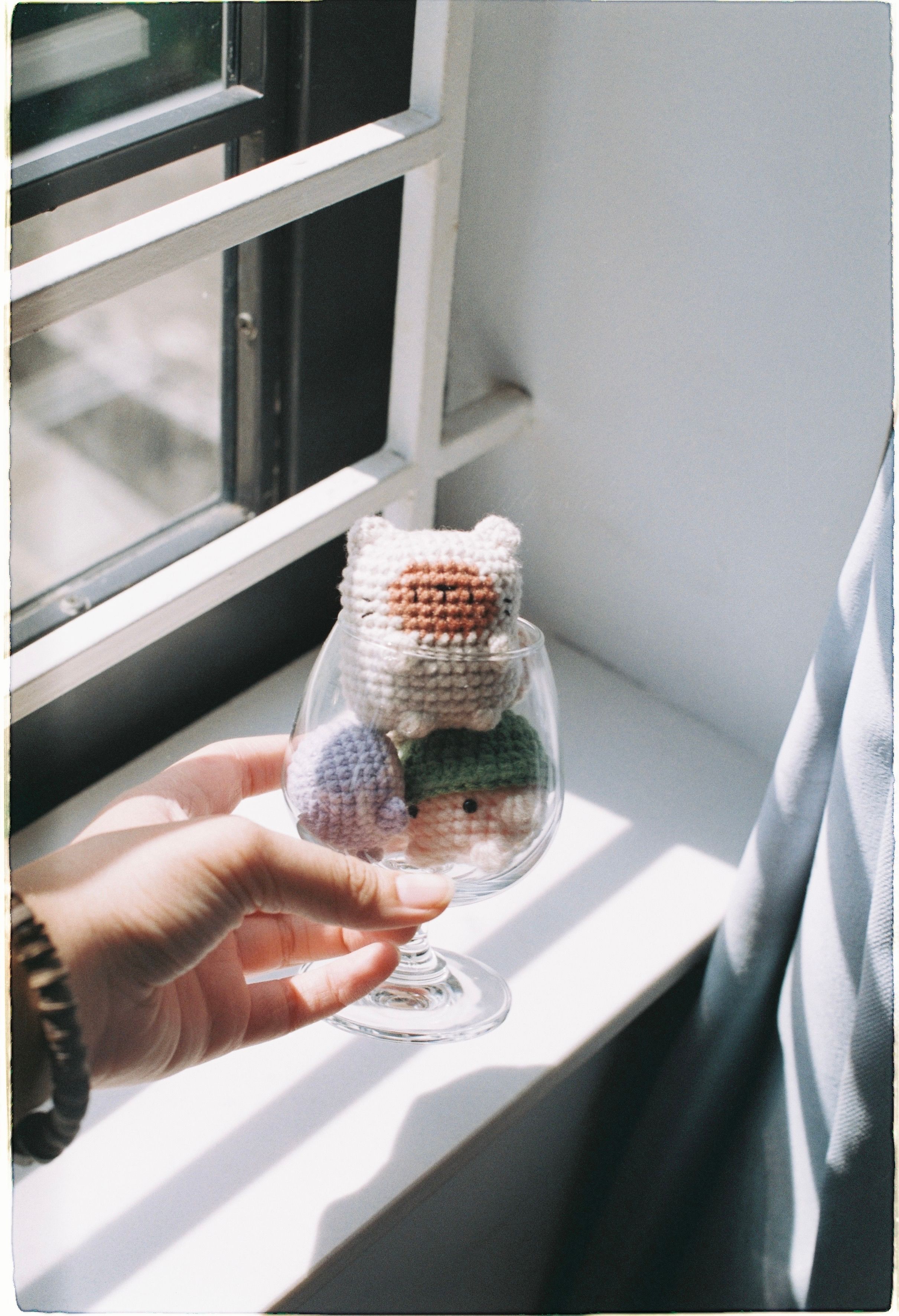 Crocheted animal toys on a sunlit windowsill — photo by stayhereforu on Pexels