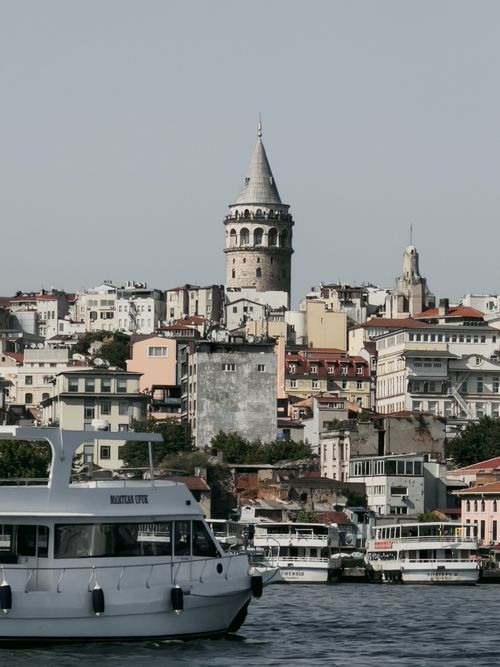 Free View of the iconic Galata Tower with boats on the Bosphorus in Istanbul, Turkey. Stock Photo