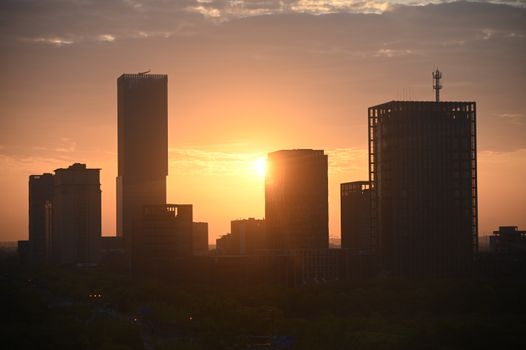 A breathtaking view of city skyscrapers silhouetted against a vibrant sunset.