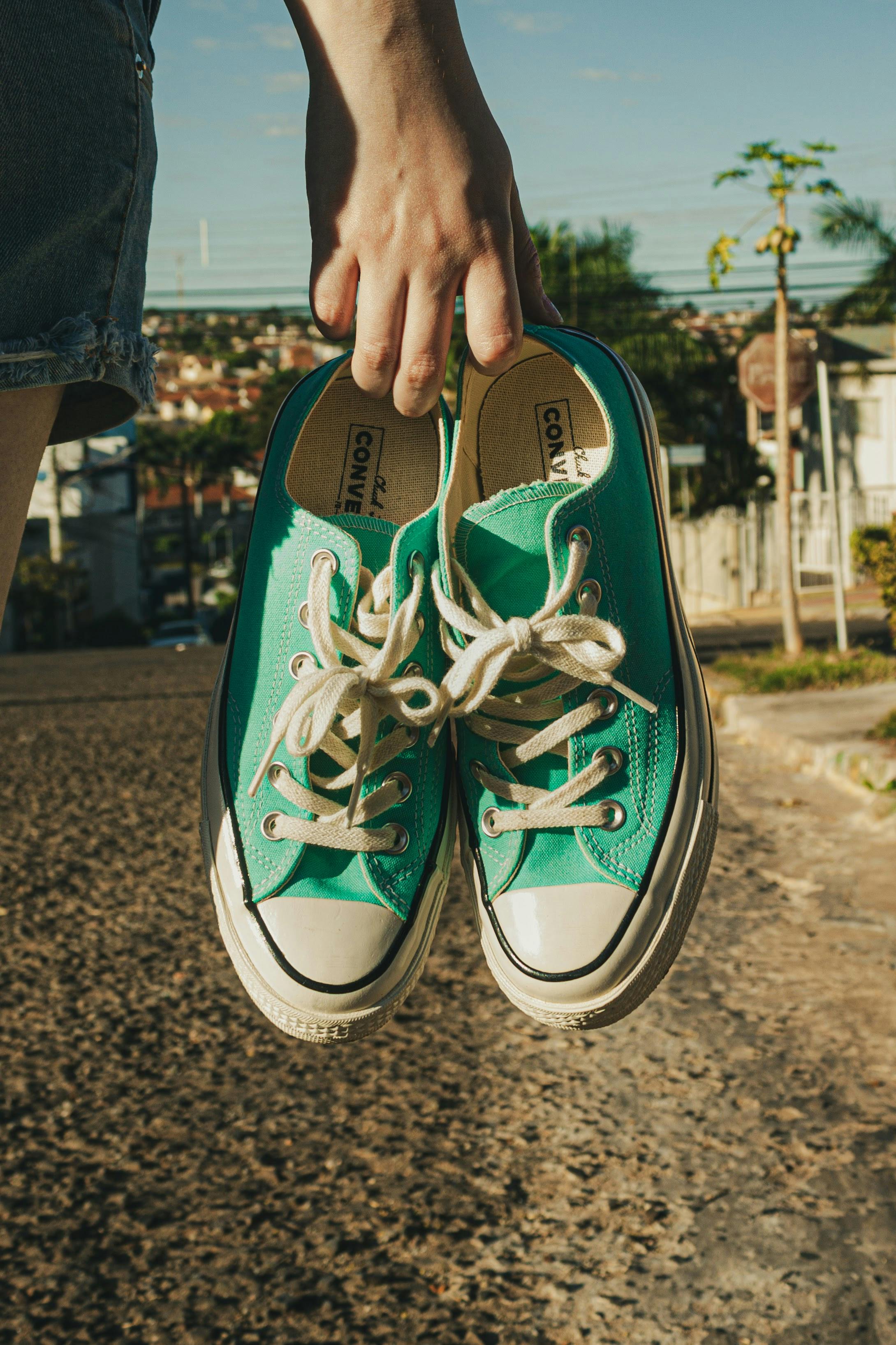 hand holding shoes