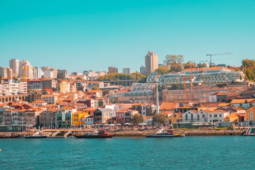 Free Vibrant skyline of Porto showcasing colorful waterfront buildings and urban landscape under a clear sky. Stock Photo