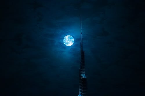 Full Moon and Burj Khalifa Spire on a Cloudy Night, Dubai, UAE