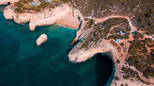Free Aerial view of the stunning rocky coastline of the Algarve, Portugal, during summer. Stock Photo