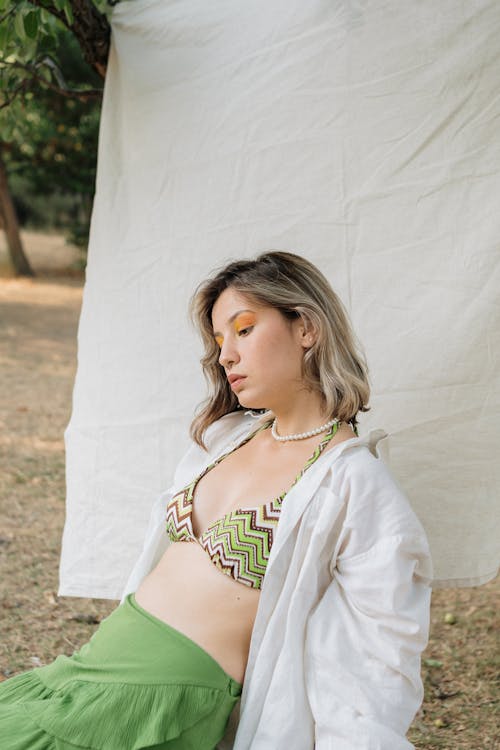 Woman in Ethnic Bra Sitting on Meadow