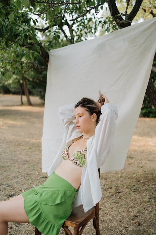 Sitting Woman in Ethnic Bra and Green Skirt