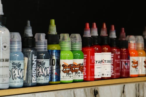 Tattoo Inks in Plastic Bottles on Shelf