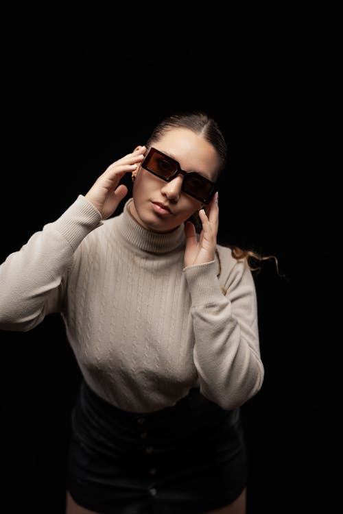 Young Woman in Sunglasses Posing in Studio 