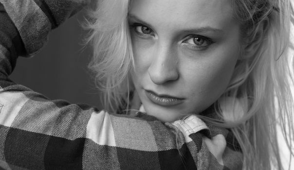 A woman with blonde hair posing for a black and white photo