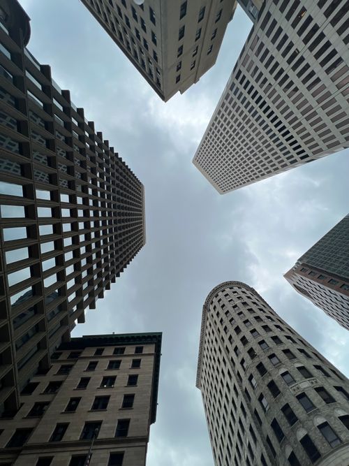 Free Low-angle view of skyscrapers against a cloudy sky, showcasing urban architecture. Stock Photo