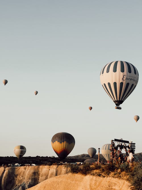 Free Multicolored Hot-Air Balloons Flying over Cappadocia Landscape Stock Photo