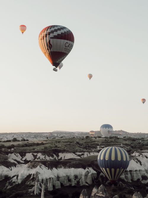 Free Majestic view of hot air balloons flying over Cappadocia's dawn landscape. Stock Photo
