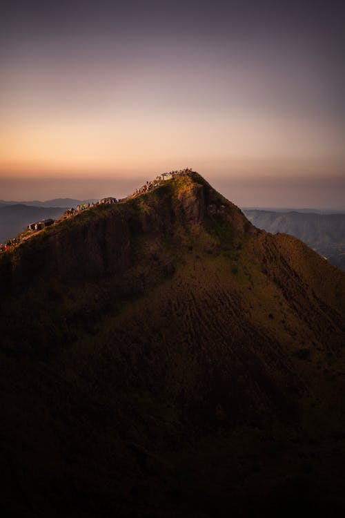 Free Crowd of Hikers on the Mountain Ridge at Dusk Stock Photo