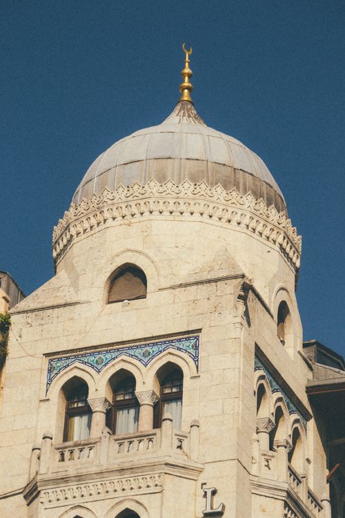 Free Close-up view of a sunlit dome of an Islamic building with intricate designs. Stock Photo