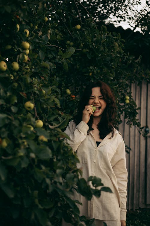 Woman Eating Sour Apples 