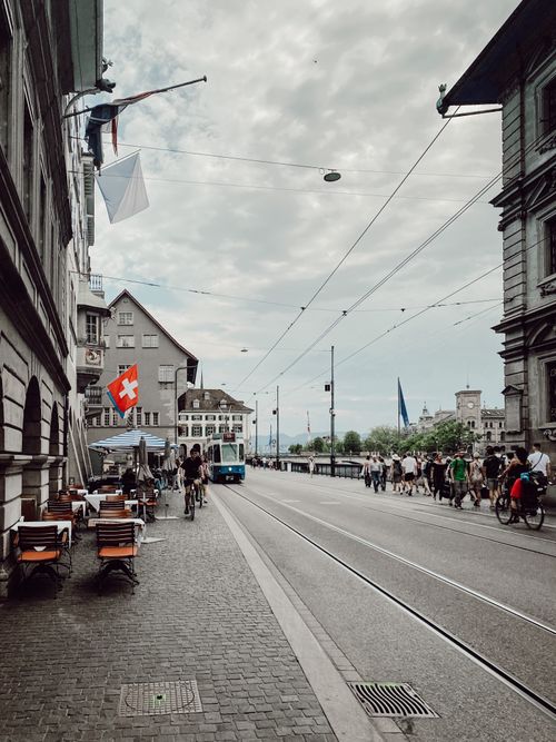 Free A bustling street scene in Zurich featuring trams, pedestrians, and iconic Swiss architecture. Stock Photo