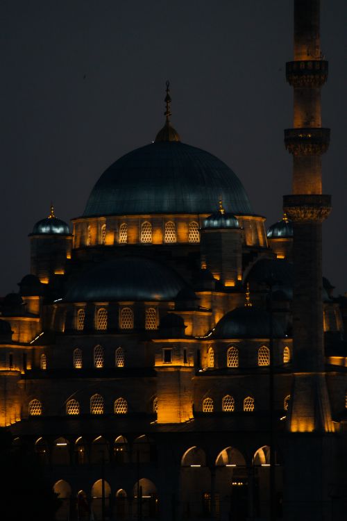 Free Captivating night view of the illuminated New Mosque in Istanbul, Turkey, showcasing its architectural beauty. Stock Photo