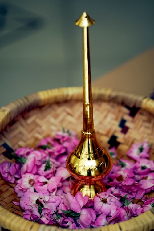 Free Golden incense burner surrounded by pink rose petals in Dammam, Saudi Arabia. Stock Photo