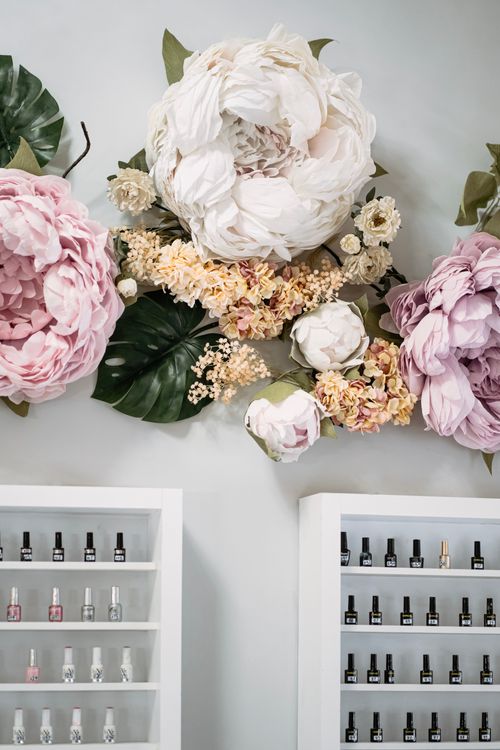Free Beautiful floral arrangement over shelves of cosmetics in a shop. Stock Photo