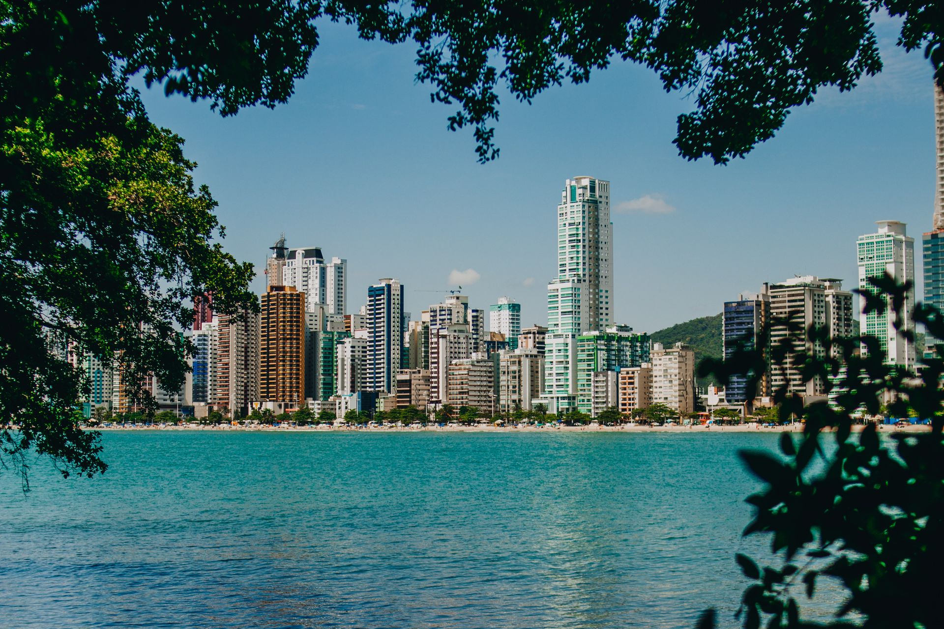 Cityscape of tropical resort with modern buildings and sandy beaches near calm blue water