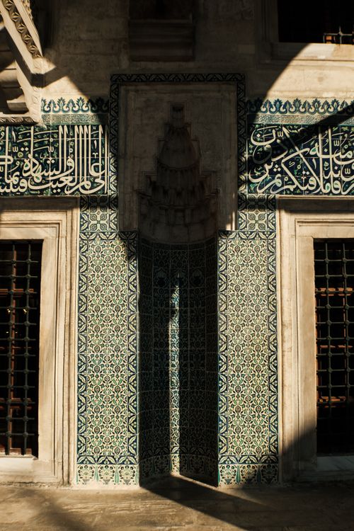 Free Beautiful mosaic facade with Arabic calligraphy and shadow play, capturing Islamic architectural elegance. Stock Photo