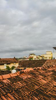 Capture of rustic rooftops under cloudy skies, showcasing urban charm and architectural style.