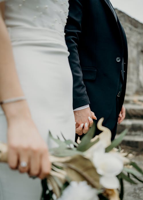 Newlyweds Couple Holding Hands