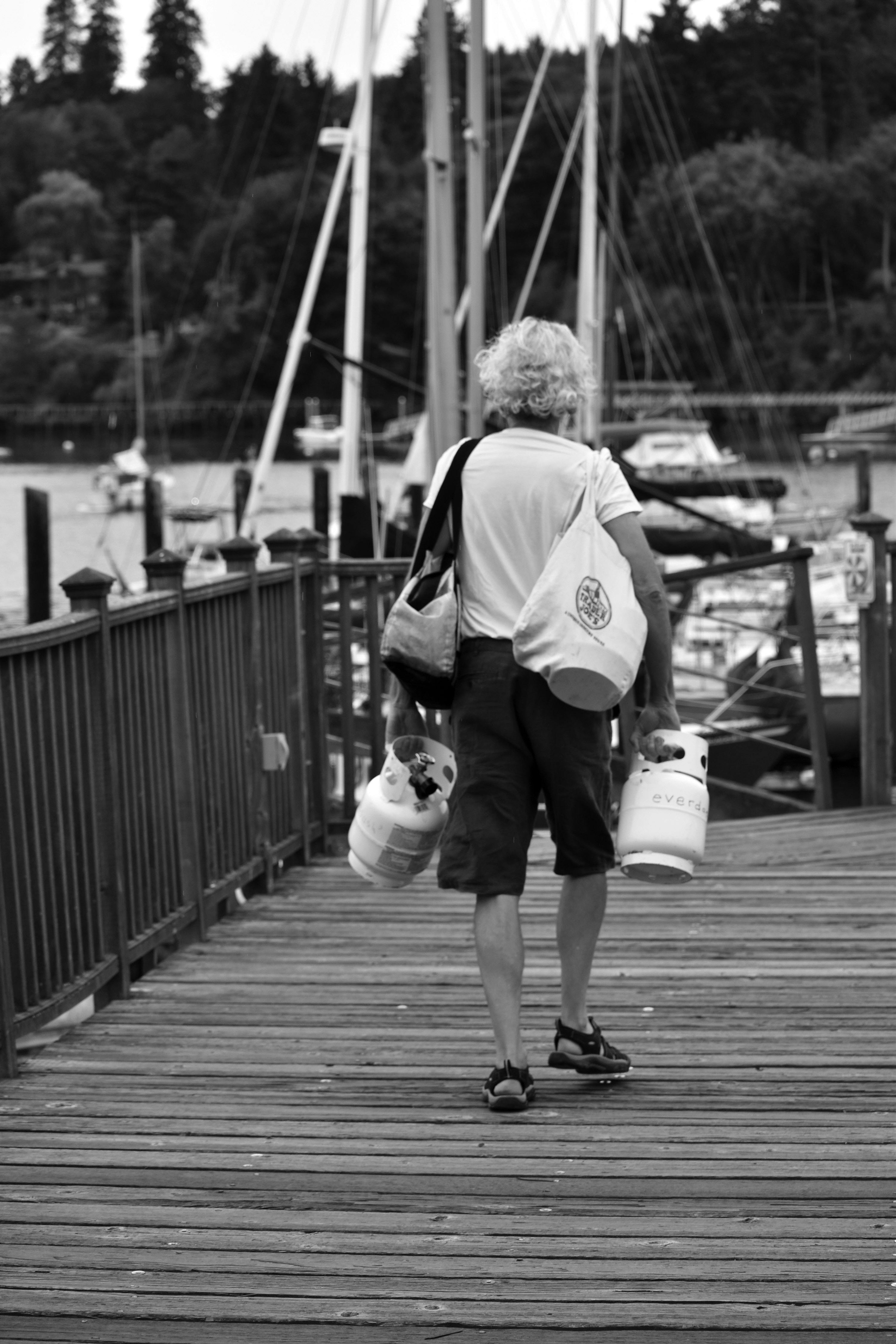 Woman with Hat Carrying Large Brown Bag in Tunnel · Free Stock Photo
