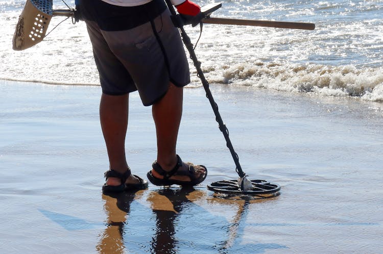 Man With Metal Detector At Beach