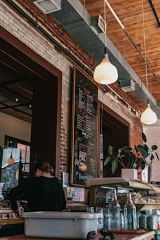 A rustic café setting with a detailed menu board and warm lighting.