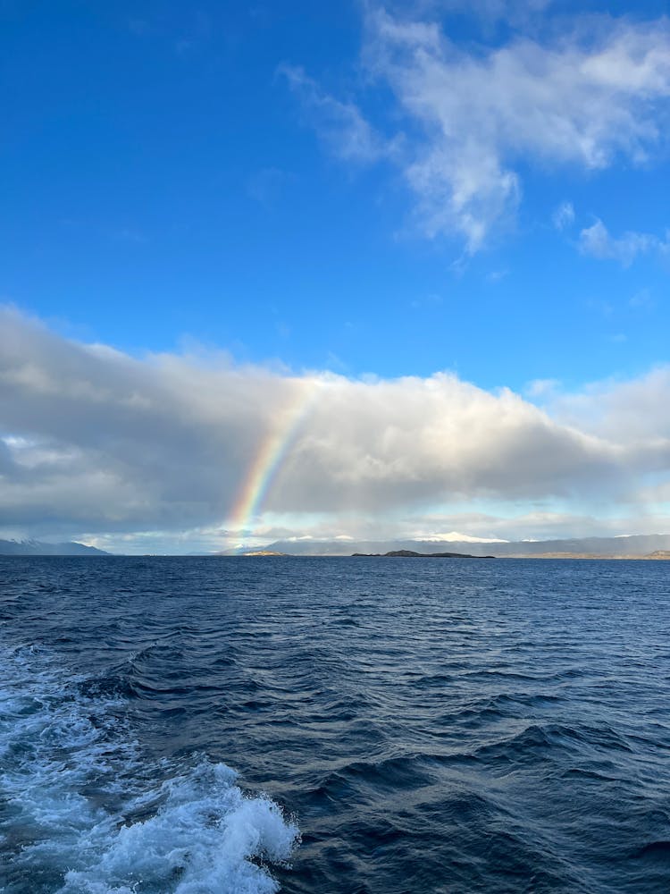 Rainbow And Cloud Over Sea