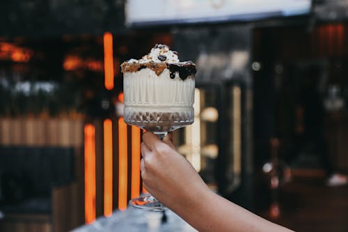 Hand Holding Sweet Cocktail with Chocolate Sauce