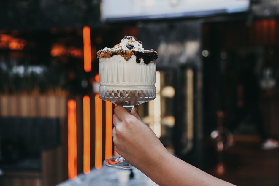 hand holding milkshake glass