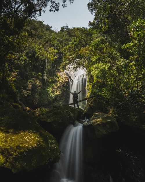 Free Hiker stands before a mesmerizing waterfall in Jepelacio, Peru, capturing the essence of nature. Stock Photo