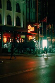 Urban nighttime scene with neon lights, pedestrians, and street ambiance in a city.