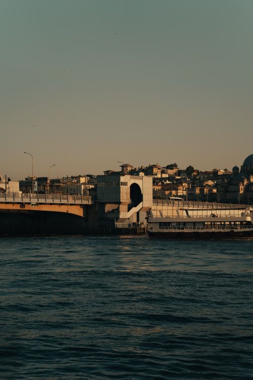 Free A serene dusk view of Galata Bridge over calm waters, capturing the essence of Istanbul's cityscape. Stock Photo