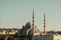 A beautiful view of a historic mosque in Istanbul with towering minarets under a clear sky.