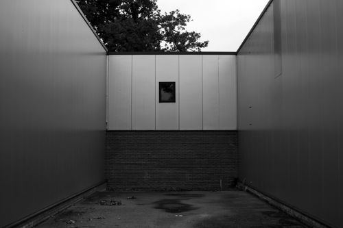 Free Black and white photo of a minimalist urban building with walls and a solitary window. Stock Photo