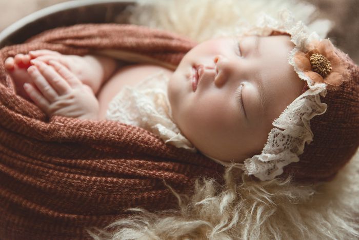 Newborn baby wrapped in soft florals