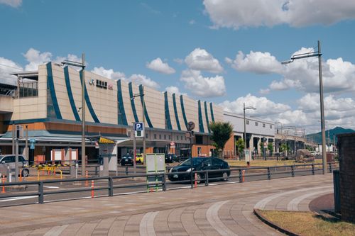 Free Exterior view of Fukuchiyama Station in Kyoto, showcasing modern architecture under a bright sky. Stock Photo