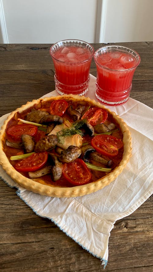 Free Meal with Vegetables and Red Juice behind Stock Photo