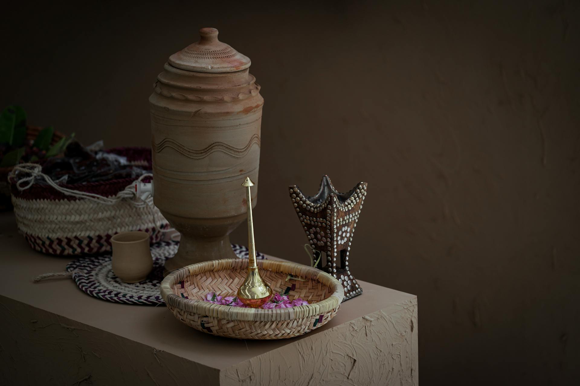 A close-up of traditional Saudi Arabian handcrafted decor including baskets and pottery.