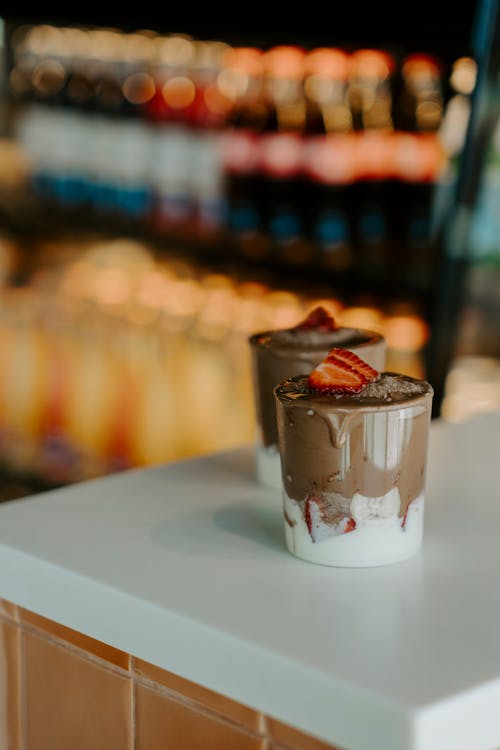 Two Glasses of Chocolate Ice Cream Dessert Topped with Strawberry