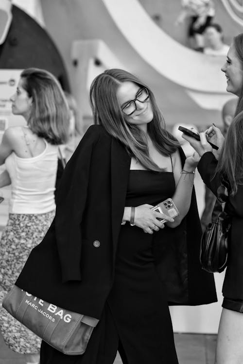 Smiling Woman in Eyeglasses and Black Suit