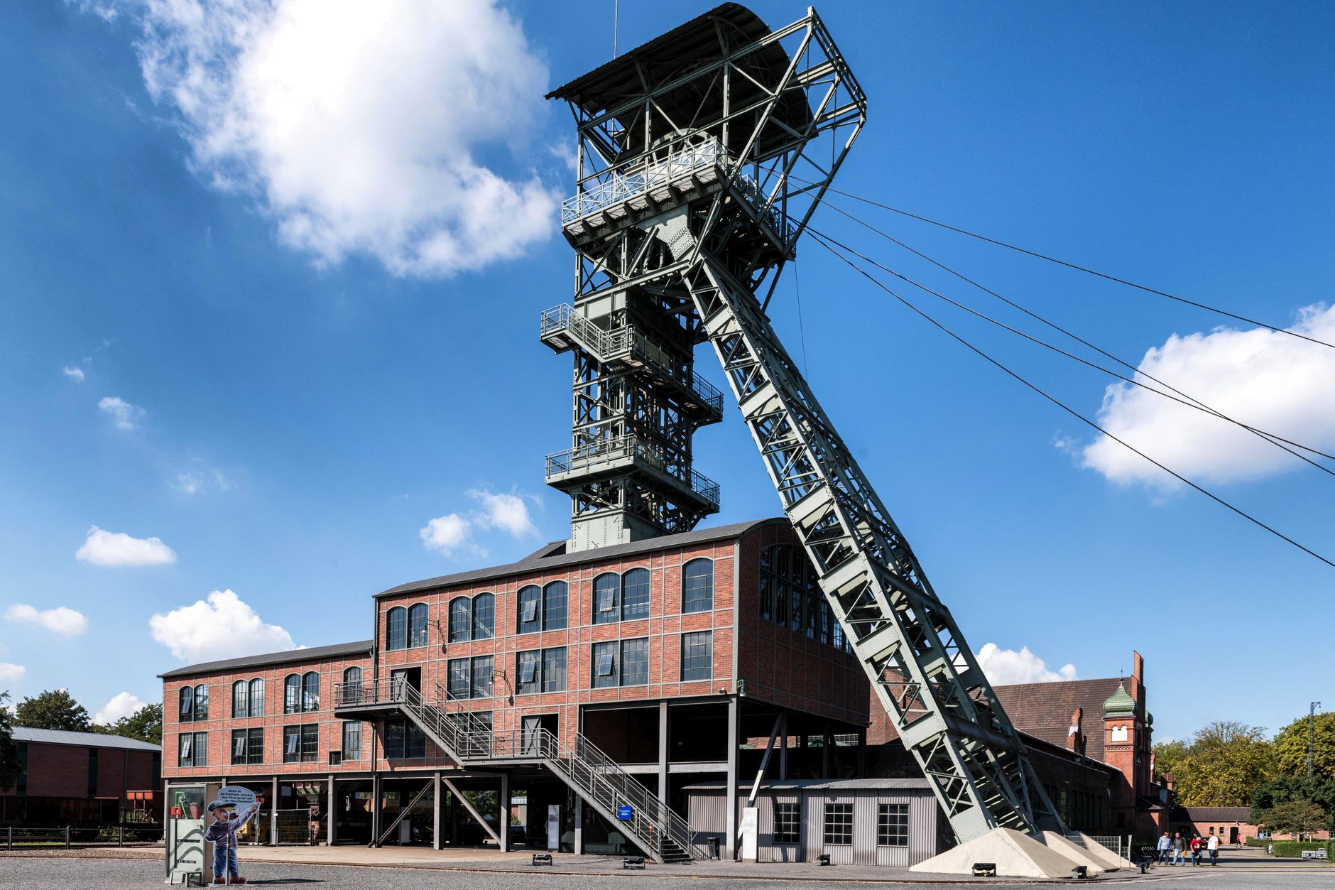 Historic industrial building with steel tower in Dortmund, Germany against blue sky.